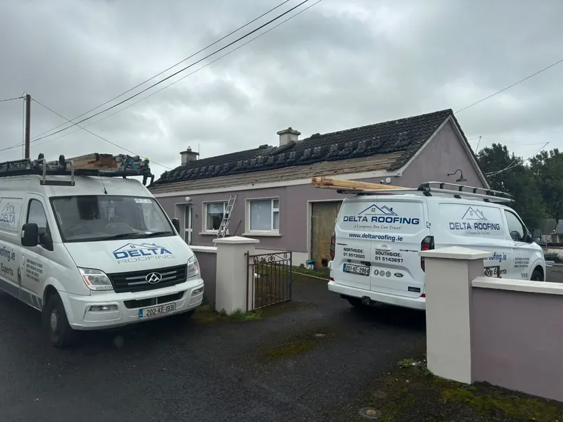 Vans outside a re-roof, Delta Roofing