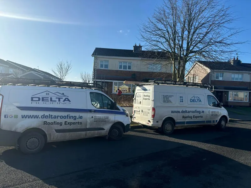 Vans and trailer on site, Delta Roofing