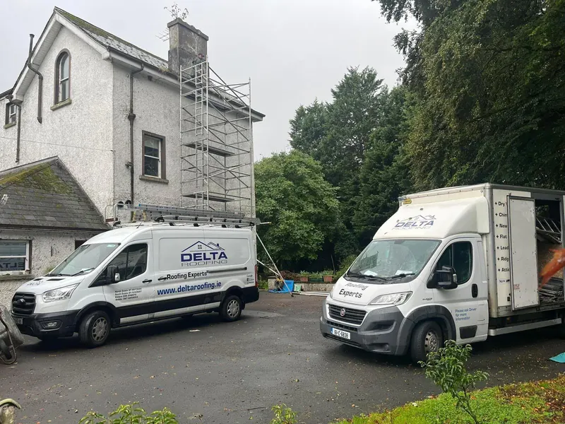 Vans at a detached house, Delta Roofing