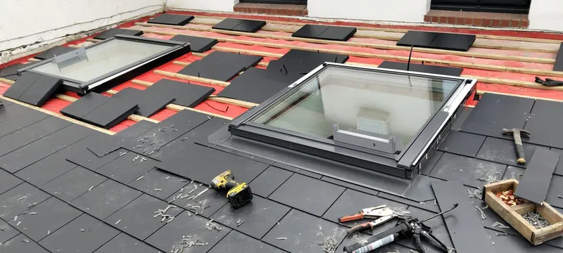 Slate going on around the windows, Delta Roofing