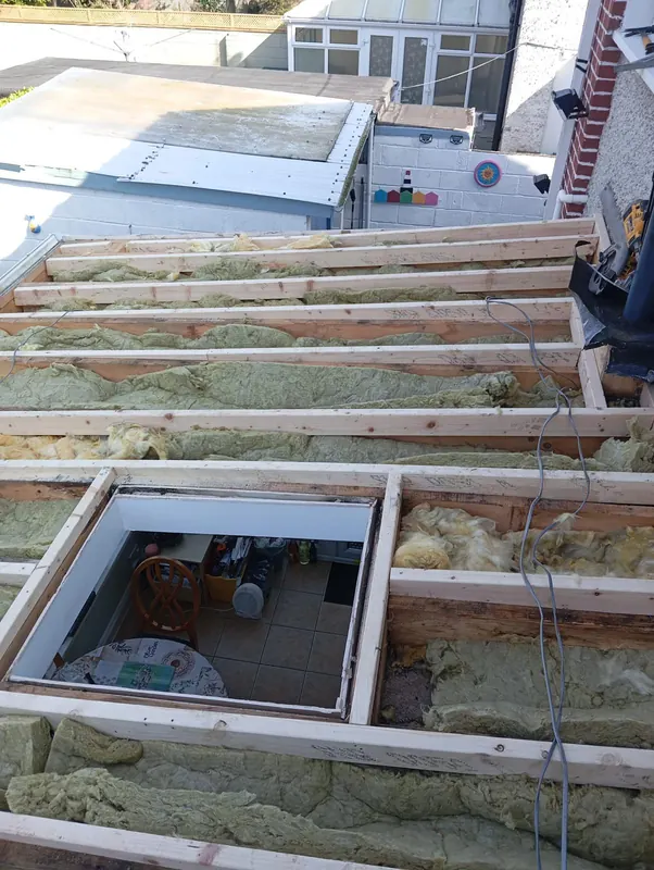 Rafter insulation around a roof window, Delta Roofing
