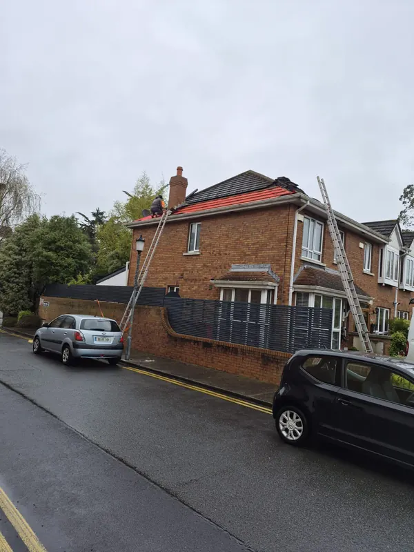 Ladder up on a redbrick semi, Delta Roofing