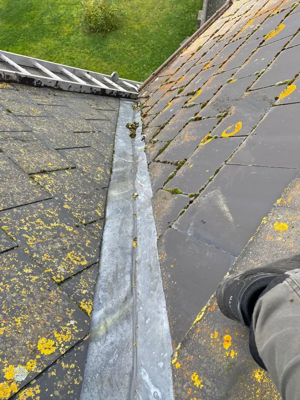 Worn valley on mossy slate, before, Delta Roofing